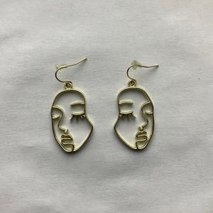 Gold face earrings